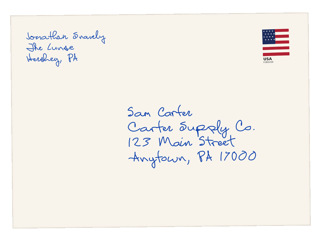 Envelope addressed by hand in blue ink to a sample recipient, with a flag stamp
